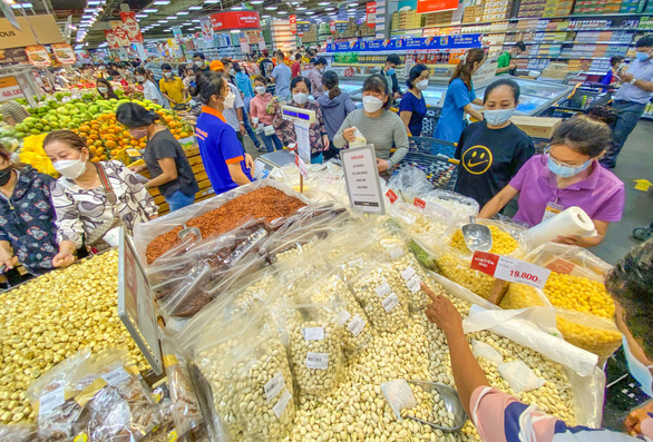 Người mua thoải mái lựa chọn hàng hóa, bánh mứt dồi dào trên các kệ của siêu thị - Ảnh: QUANG ĐỊNH